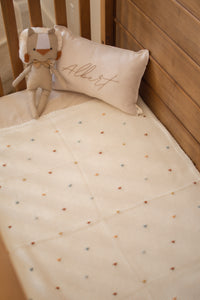 Crocheted blanket with multicolored polka dots