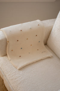Crocheted blanket with multicolored polka dots