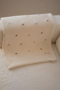 Crocheted blanket with multicolored polka dots