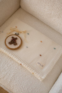 Crocheted blanket with multicolored polka dots